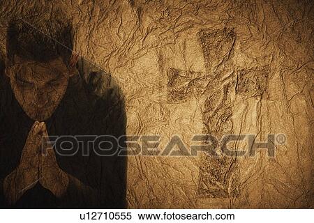 Stock Photography - Composition of man praying to Jesus. Fotosearch