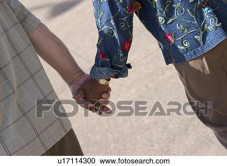 Couple hand in hand View Large Photo Image Stock Image - Couple hand in hand. Fotosearch