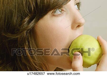 Eating an apple View Large Photo Image Stock Photo - Eating an apple. Fotosearch
