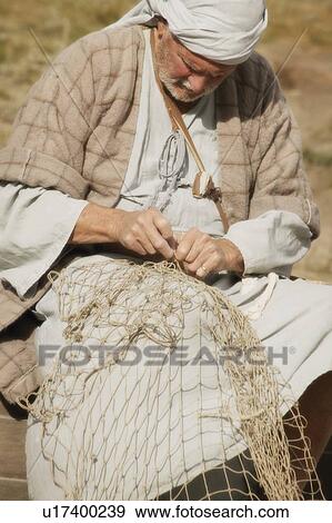 Stock Photo - Fisherman with net. Fotosearch