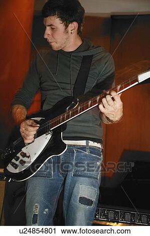 Man plays his electric guitar View Large Photo Image Stock Image - Man plays his electric guitar. Fotosearch