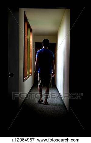 Man walks down hallway View Large Photo Image Stock Photo - Man walks down hallway. Fotosearch