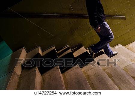 Picture - Person walking down stairs. Fotosearch