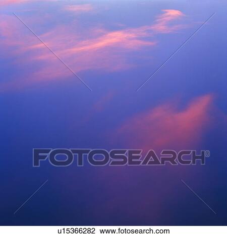 Stock Image - Pink clouds in a blue sky. Fotosearch