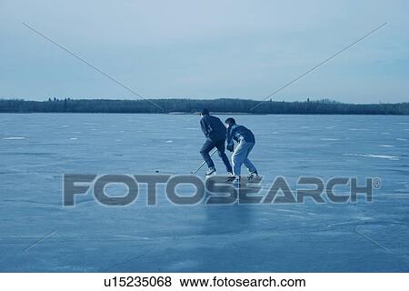 Playing hockey together View Large Photo Image Stock Photo - Playing hockey together. Fotosearch