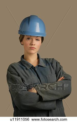 Stock Photograph - Portrait of a woman with hard hat. Fotosearch