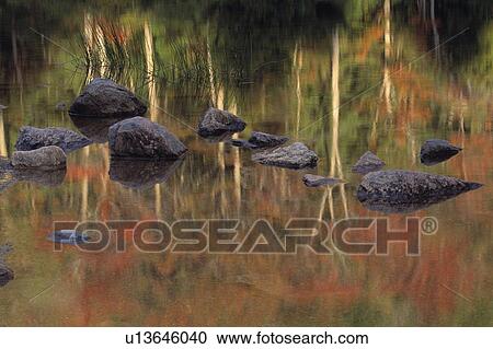 Stock Image - Rocks reflected in Bubble Pond. Fotosearch