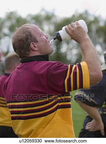 Rugby player drinking water View Large Photo Image Stock Image - Rugby player drinking water. Fotosearch