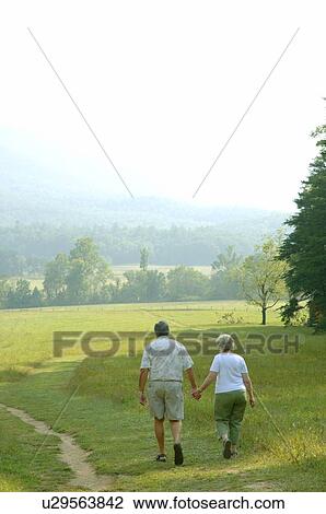 Stock Image - Seniors go for a walk. Fotosearch