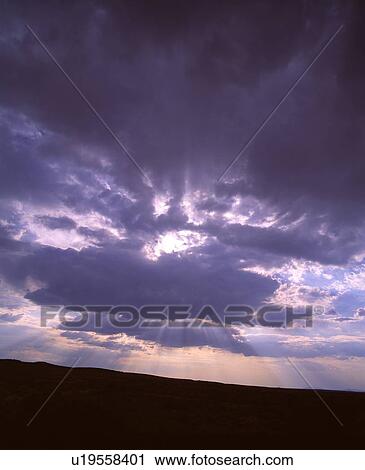 Sun rays shining through clouds View Large Photo Image Stock Image - Sun rays shining through clouds. Fotosearch