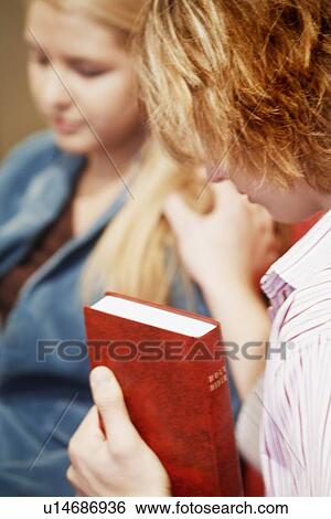 Teen prays for another View Large Photo Image Stock Photograph - Teen prays for another. Fotosearch