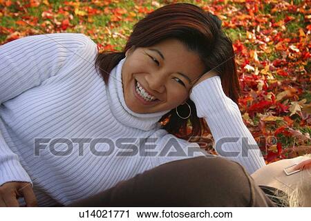 Stock Image - Two women talking together. Fotosearch