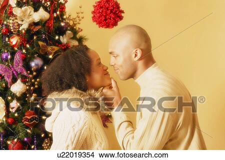 Picture - Under the mistletoe. Fotosearch