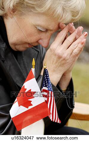 Woman praying over flags from different countries View Large Photo Image Stock Photo - Woman praying over flags from different countries. Fotosearch