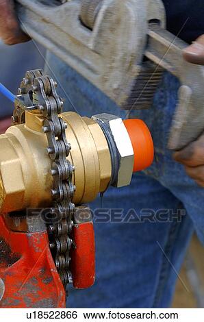 Worker fixing object with wrench View Large Photo Image Stock Photograph - Worker fixing object with wrench. Fotosearch