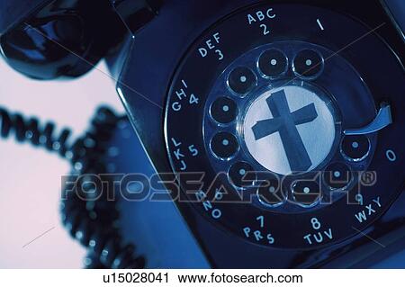 Stock Image - A rotary phone with a cross. Fotosearch