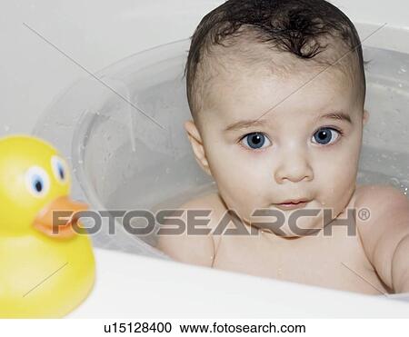 Stock Image - Baby in bath tub. Fotosearch
