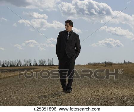 Businessman walking on road View Large Photo Image Stock Photograph - Businessman walking on road. Fotosearch