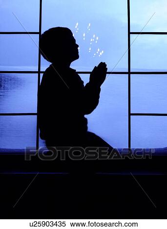 Stock Photography - Child praying. Fotosearch