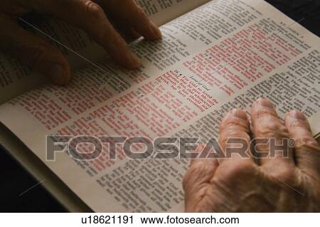 Stock Image - Closeup of senior reading Bible. Fotosearch