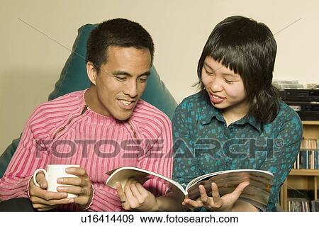 Couple reading together View Large Photo Image Stock Photo - Couple reading together. Fotosearch