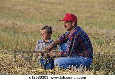 Farmer and son in field View Large Photo Image Stock Image - Farmer and son in field. Fotosearch