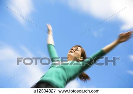 Stock Photo - Girl with arms raised. Fotosearch