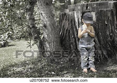 Stock Image - Little boy with ice cream cone. Fotosearch