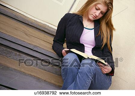 Stock Image - Reading a book. Fotosearch