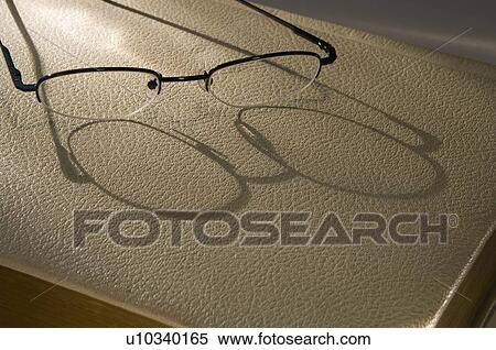Reading glasses on book View Large Photo Image Stock Photography - Reading glasses on book. Fotosearch