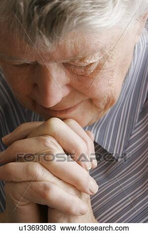 Senior woman praying View Large Photo Image Stock Image - Senior woman praying. Fotosearch