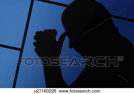Stock Photograph - Silhouette of a man praying. Fotosearch