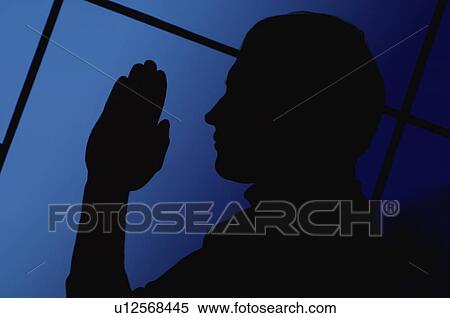 Stock Photography - Silhouette of a man praying. Fotosearch