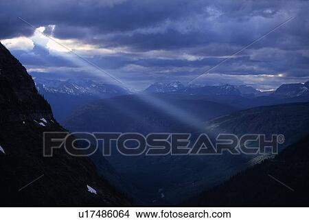 Sunbeams streaming through clouds View Large Photo Image Picture - Sunbeams streaming through clouds. Fotosearch