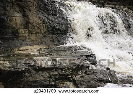 Water cascading over rocks View Large Photo Image Stock Photo - Water cascading over rocks. Fotosearch