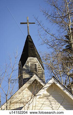 Picture - Weathered cross on steeple of church. Fotosearch