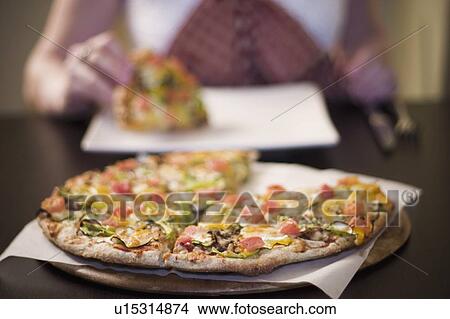 Woman eating pizza, front view View Large Photo Image Picture - Woman eating pizza, front view. Fotosearch