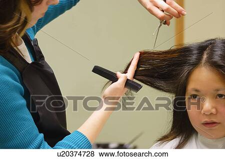 Stock Photo - Woman getting a haircut. Fotosearch
