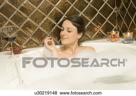 Stock Photo - Woman in the bath tub. Fotosearch