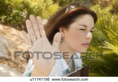 Woman in worship View Large Photo Image Stock Photograph - Woman in worship. Fotosearch