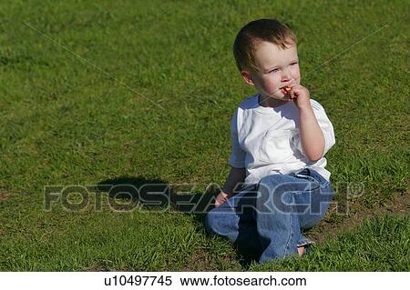 Stock Photography - Young boy having a snack. Fotosearch