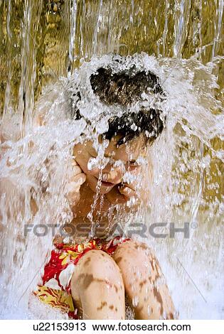Young boy under waterfall View Large Photo Image Stock Image - Young boy under waterfall. Fotosearch