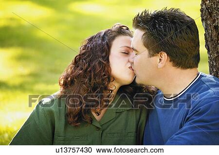 Stock Image - Young couple kissing. Fotosearch