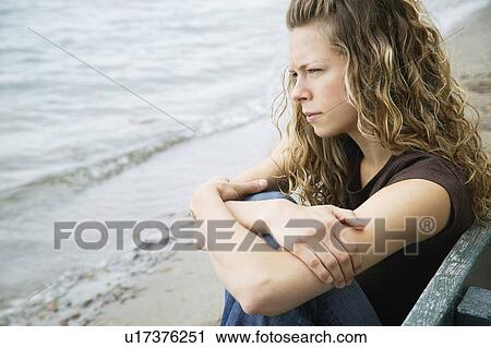 A young adult woman reflects on the beach View Large Photo Image Stock Image - A young adult woman reflects on the beach. Fotosearch