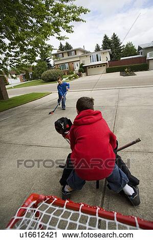 Stock Image - A young goalie anticipates a shot on goal. Fotosearch