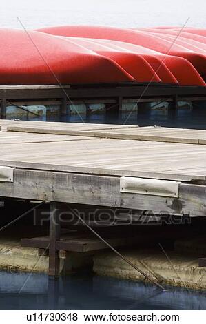 Stock Photo - Canoes on the pier. Fotosearch