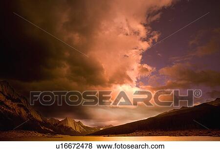 Dark and softly lit clouds overhead View Large Photo Image Stock Photo - Dark and softly lit clouds overhead. Fotosearch