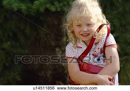 Stock Photograph - Girl holding purse. Fotosearch