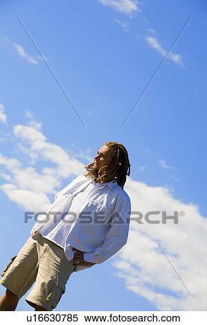 Man standing outdoors View Large Photo Image Stock Photography - Man standing outdoors. Fotosearch