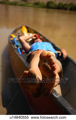 Muddy feet, relaxing in the canoe View Large Photo Image Stock Photography - Muddy feet, relaxing in the canoe. Fotosearch
